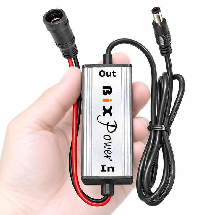 Small BiXPower high efficiency 24V DC converter shown in hand for size comparison
